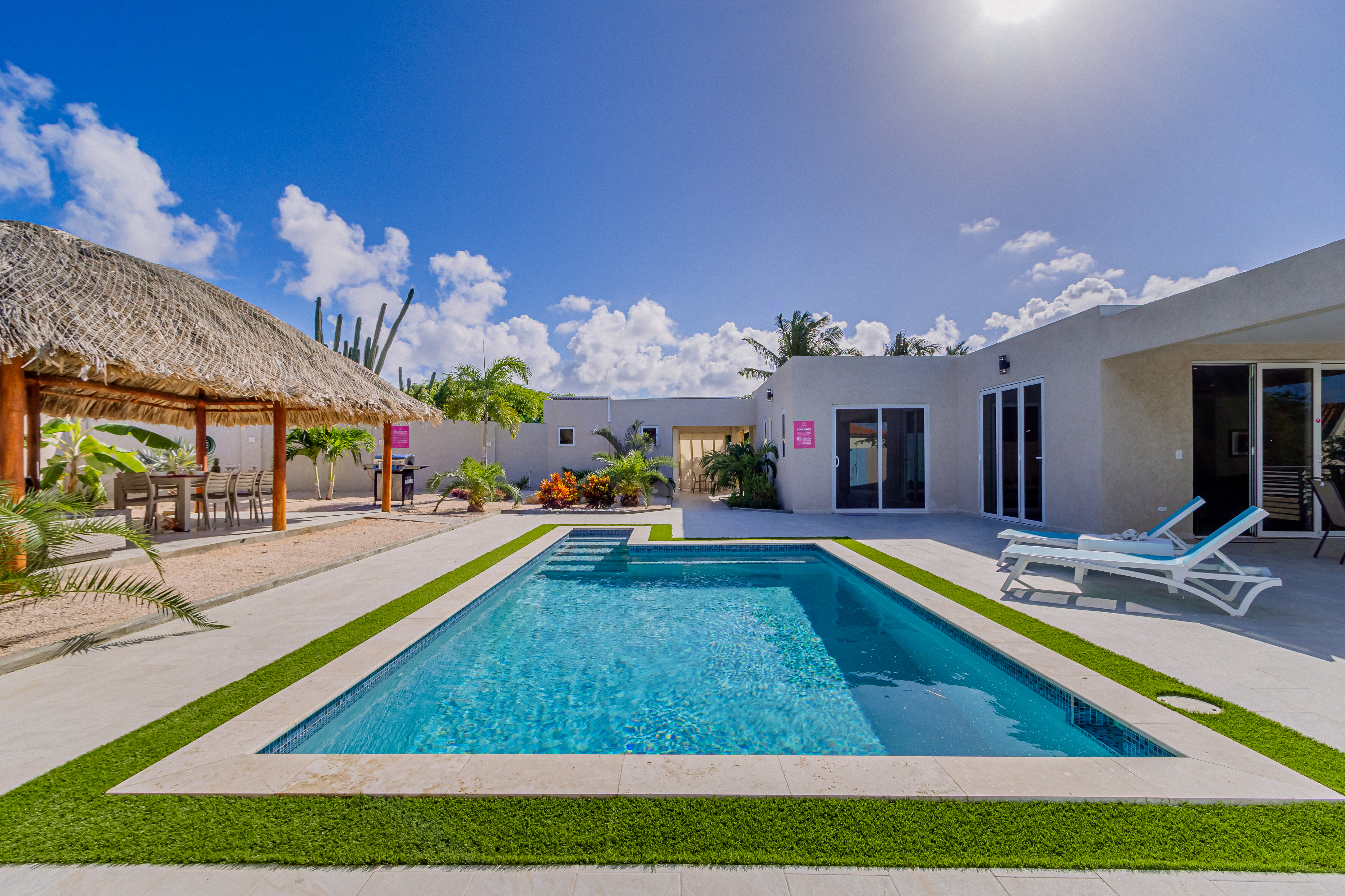Luxury pool area of the 4BR Home in Noord, Aruba - Lush and refreshing environment - Cozy beach chairs available - Beautifully sunbathed space makes the soul peaceful  - Experience the comfort at the best