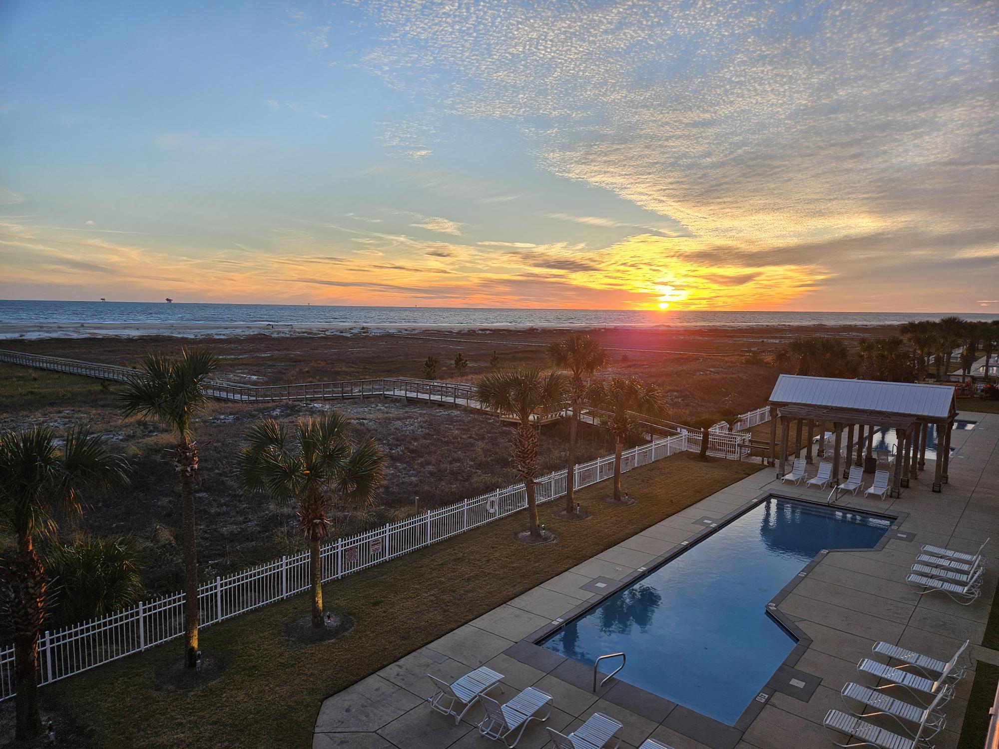 On Beach Time Sunset over Gulf and Communal Pool from Balcony