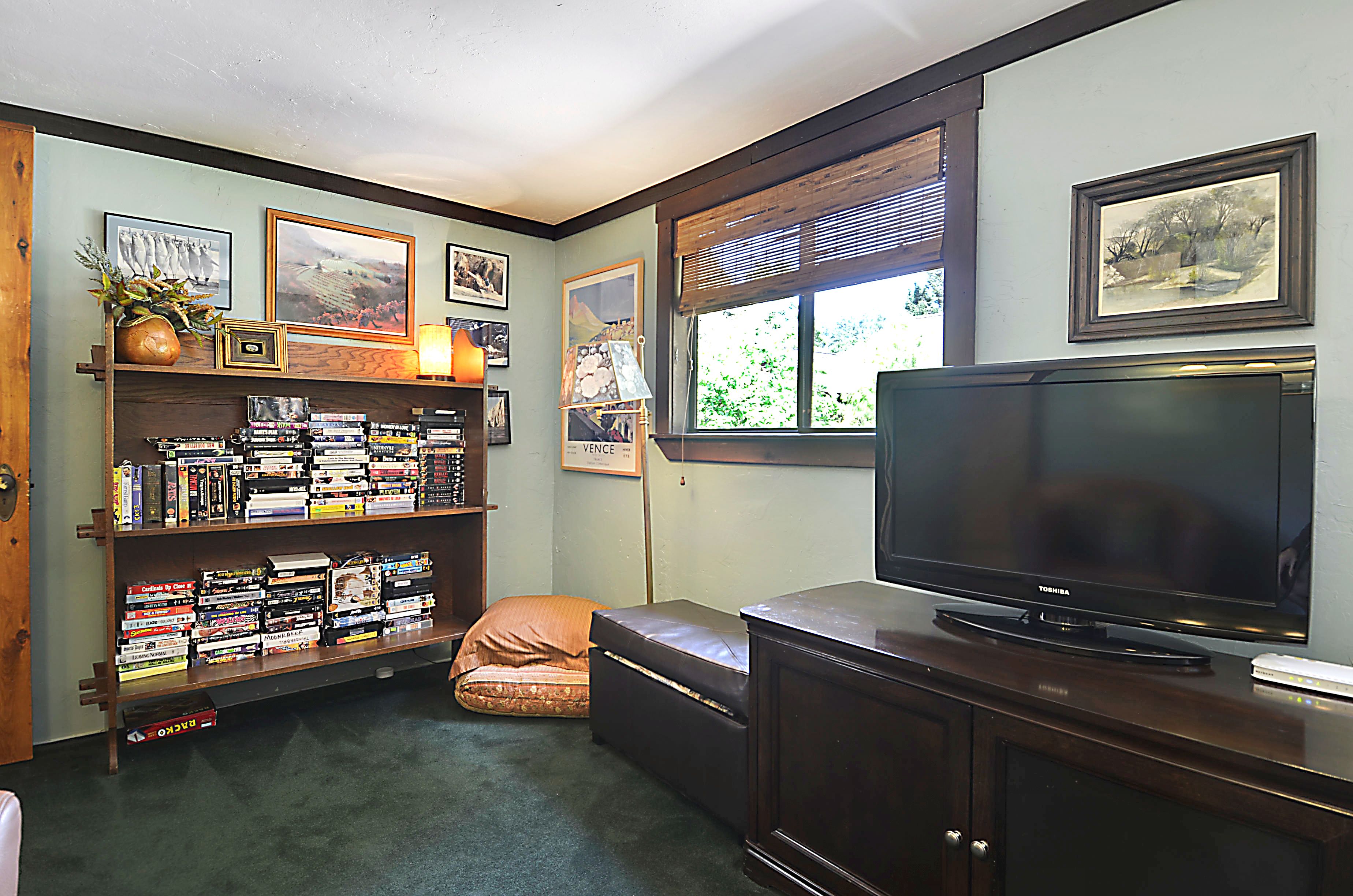 The "bonus" room has a TV, comfortable seating, movie library and the second full bathroom.