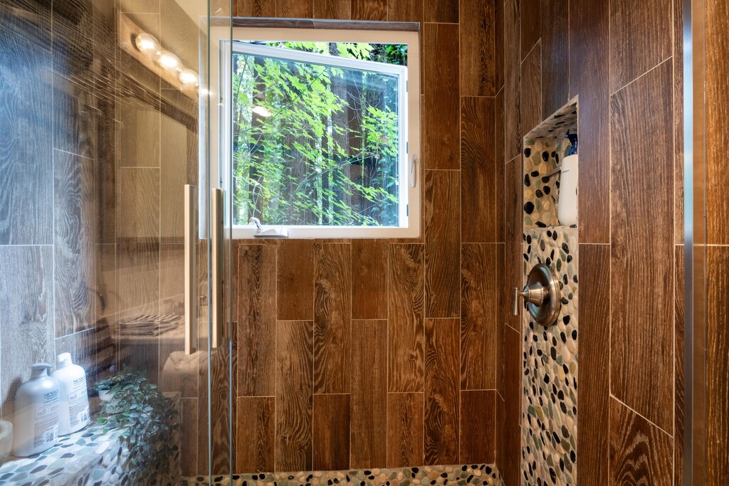 Natural light, filtered by redwood branches, adds to the sense of being in nature with the comforts of indoor plumbing.