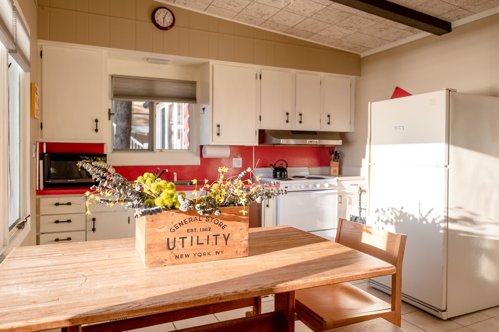 The kitchen is fully stocked with cookware, dishes, utensils, and appliances for preparing meals at the cottage during your sta.