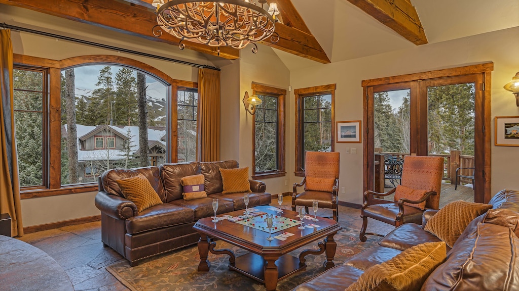 Great room with mountain resort views and deck access