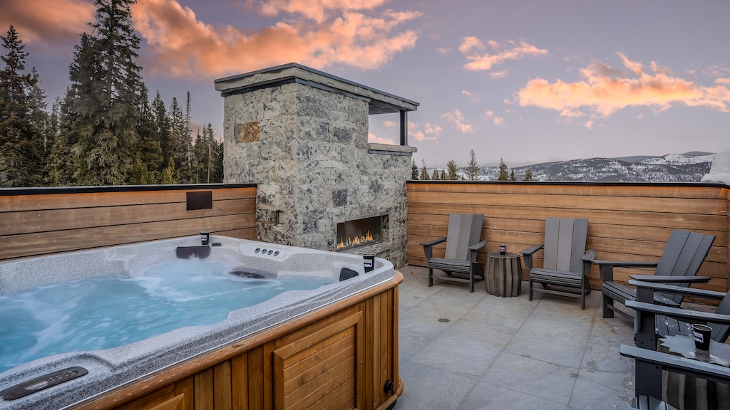 Private hot tub and outdoor gas fireplace on the roof level