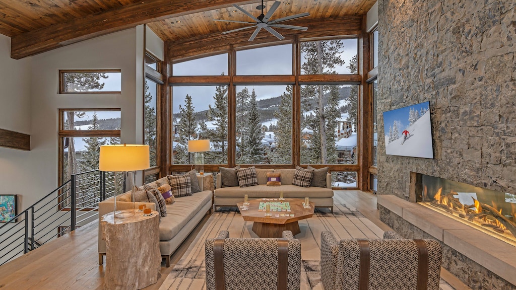 Spacious great room with TV, gas fireplace, and mountain resort views