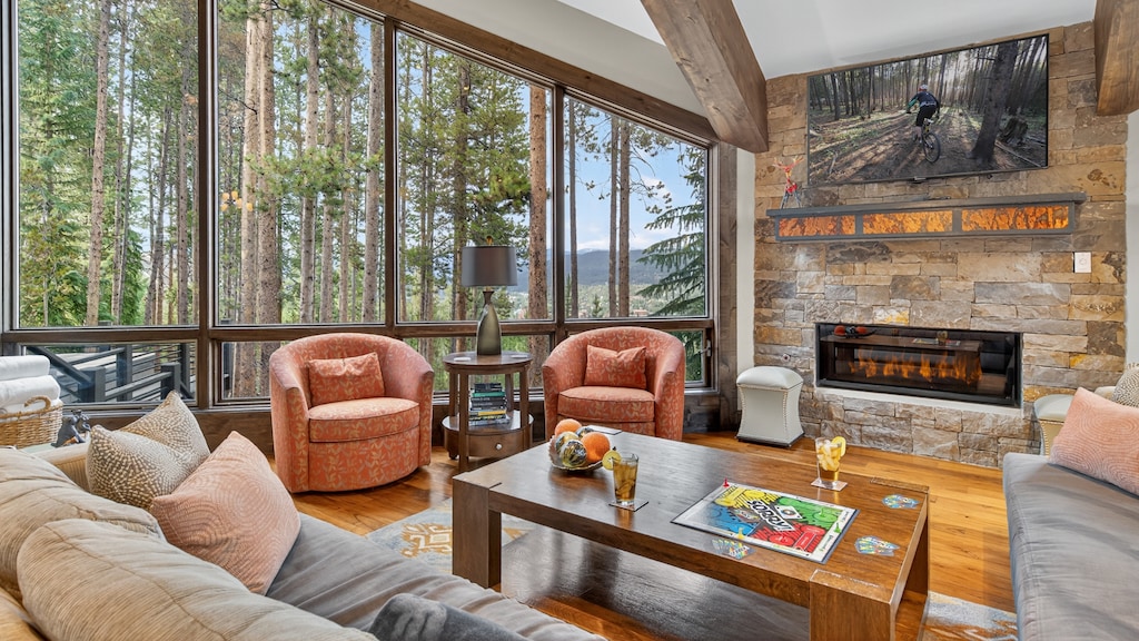 Living area with fireplace and wooded views