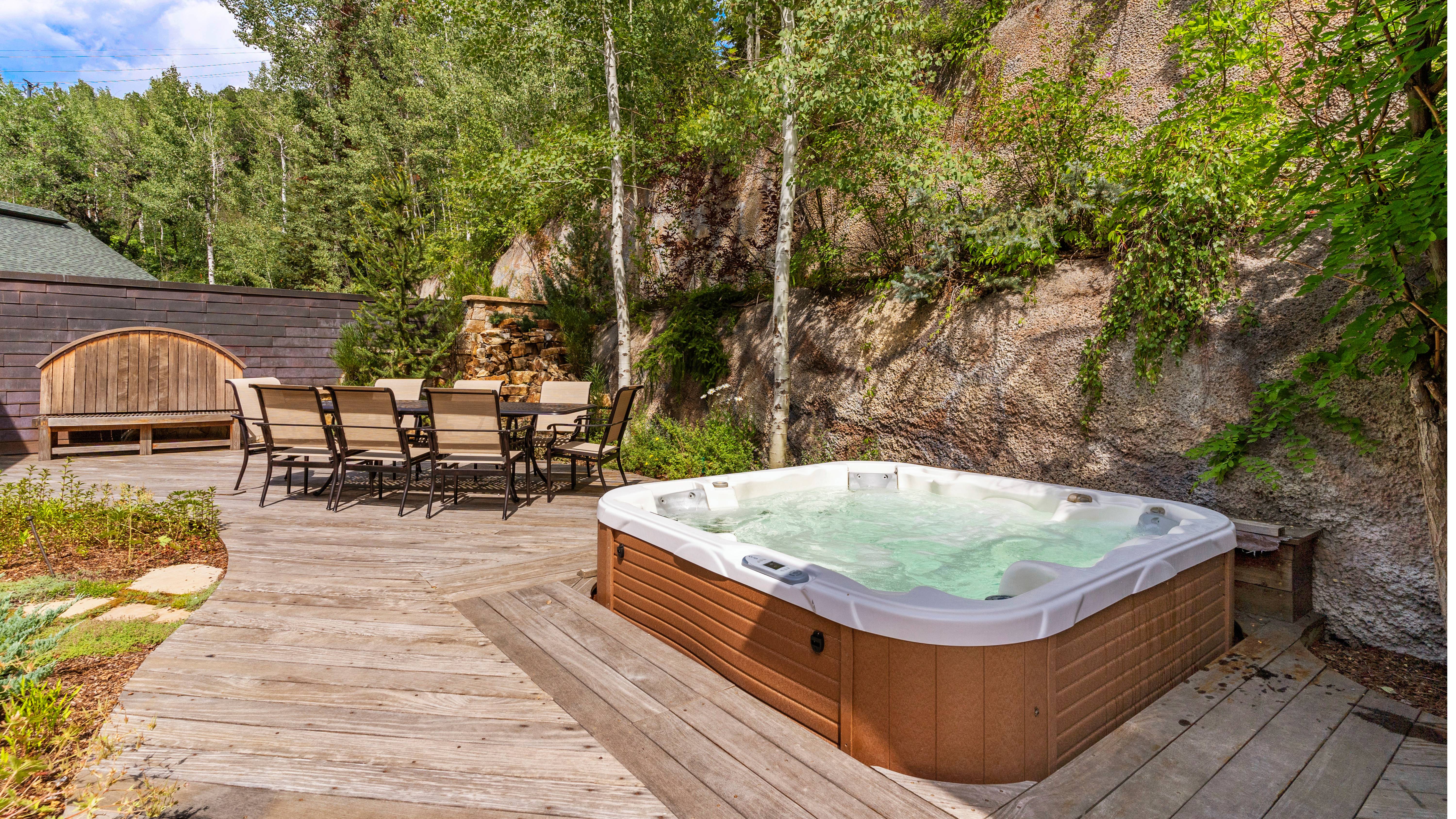 Private hot tub and patio dining area in summer