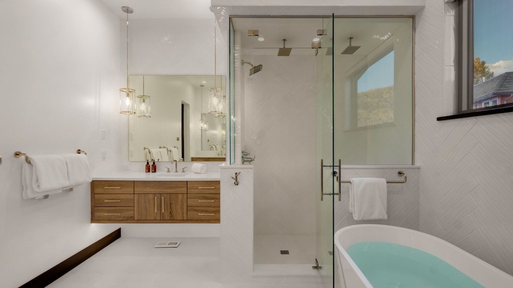 Bedroom 1, Main Level - Primary ensuite with separate vanities and 3-head shower