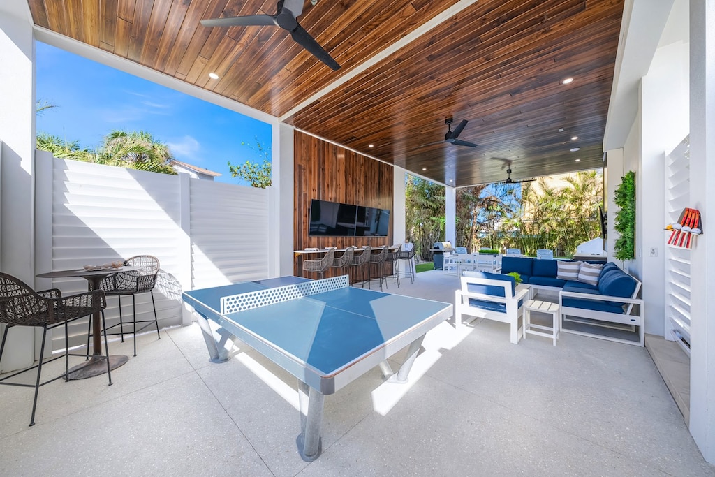 Daytime - Covered Pool Area - 3 HD TVs - Outdoor Dining - BBQ Grill - Ping Pong - and Lounge Area