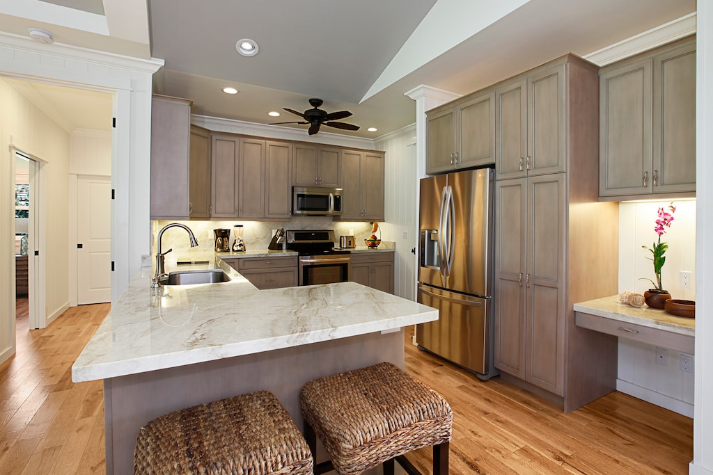 Cook with ease in the well-appointed kitchen with quartz counters, stainless steel appliances, and bar seating.