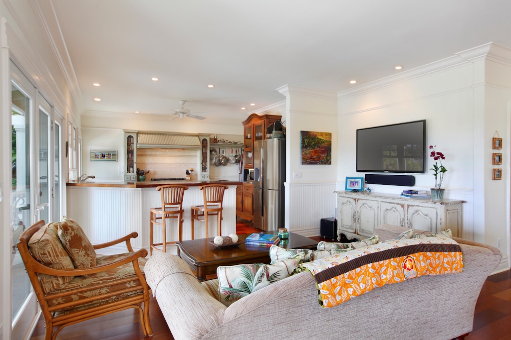 Cozy family room with built-in entertainment, plush seating, and an open kitchen view.