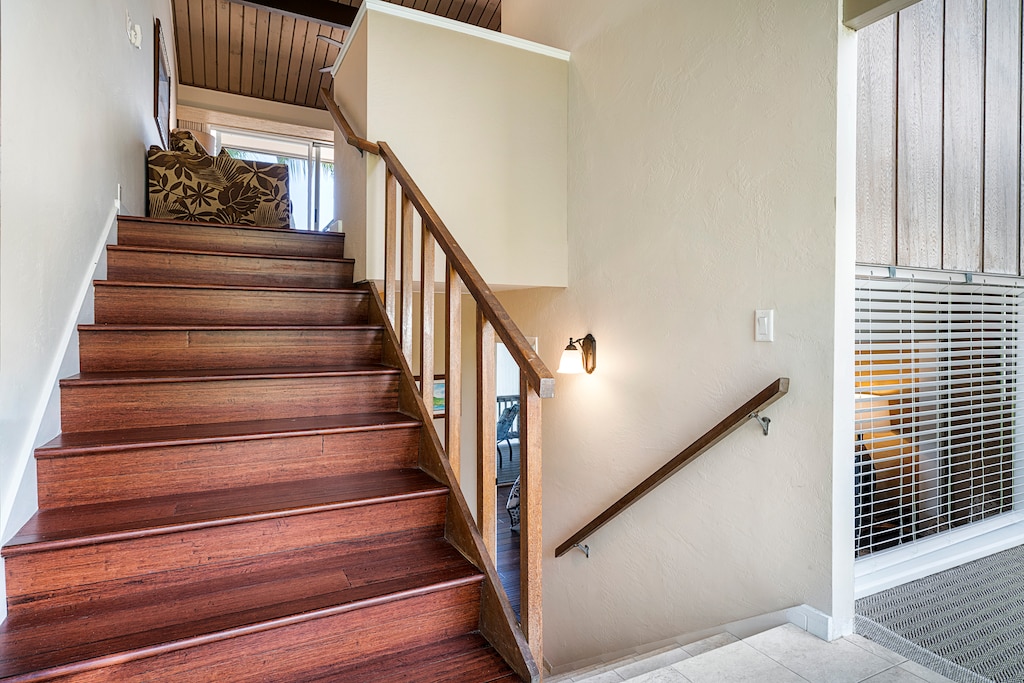 Stairs leading from the entry to the upstairs living and downstairs bedroom