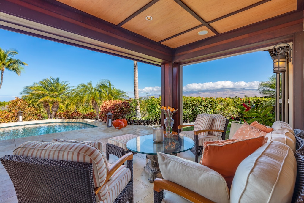 Relax in your shaded poolside cabana with plush seating and panoramic garden views.