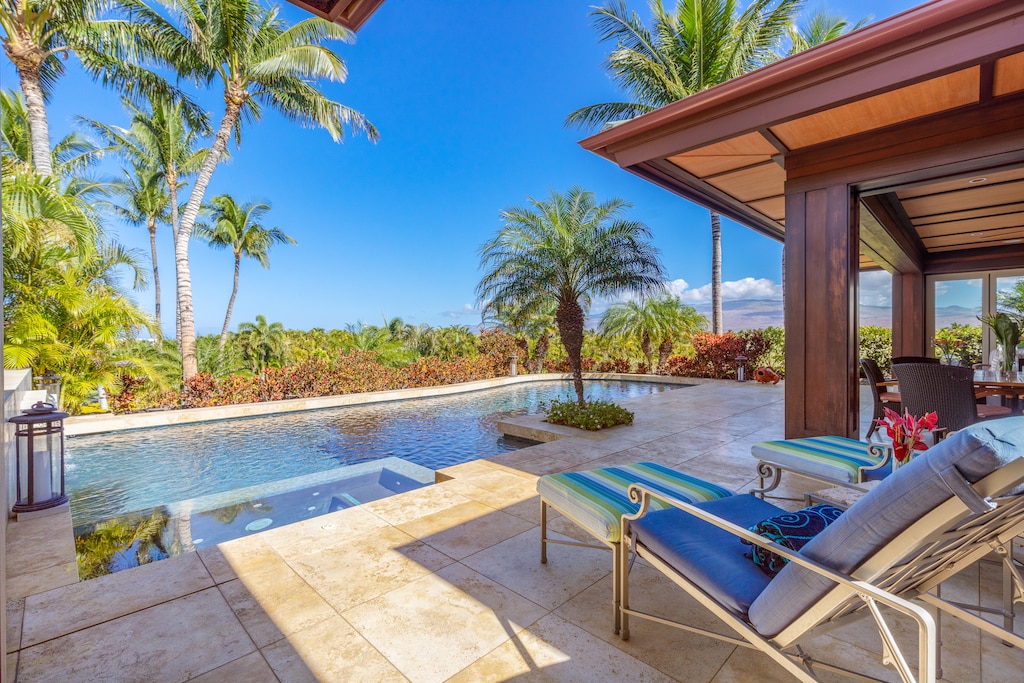 Soak up the sun from your private loungers beside the sparkling pool and lush landscaping.