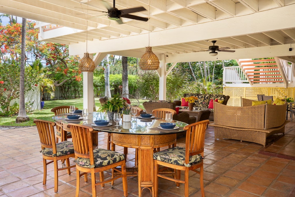 Relax over meals in the cozy outdoor dining space surrounded by lush greenery.