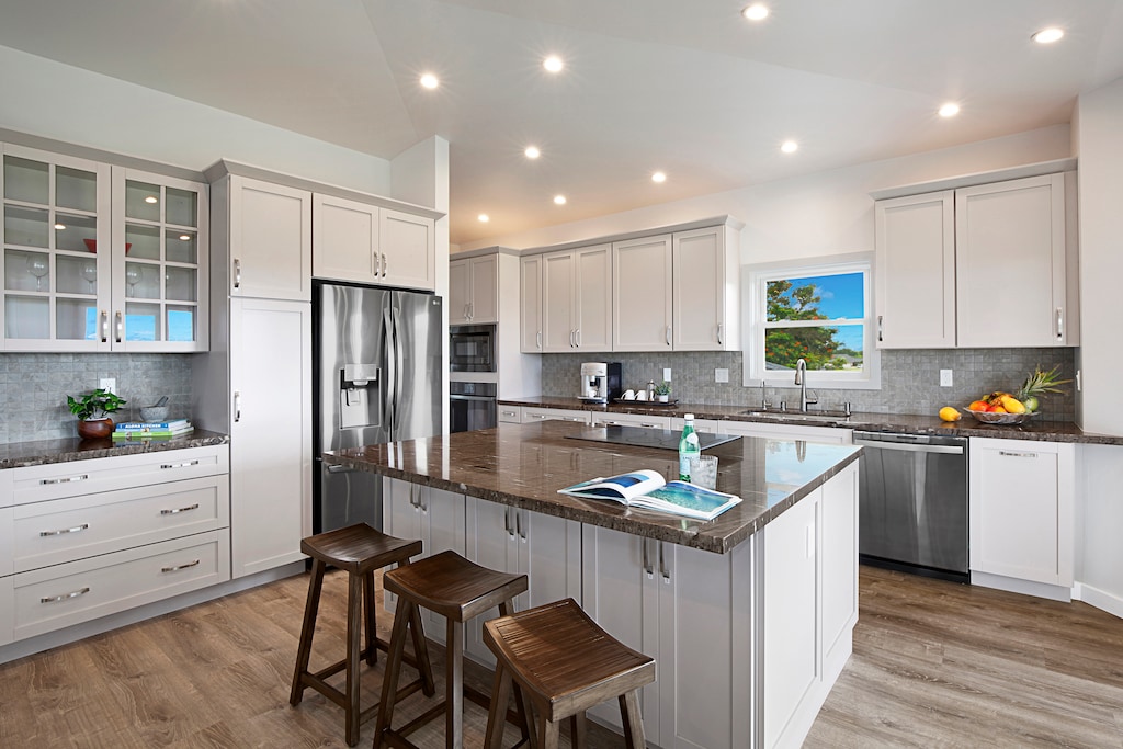 Modern kitchen with sleek appliances and a functional layout, perfect for preparing meals with ease.