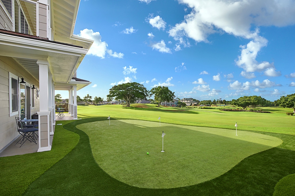 Private putting green surrounded by tropical landscaping, perfect for practicing your short game.