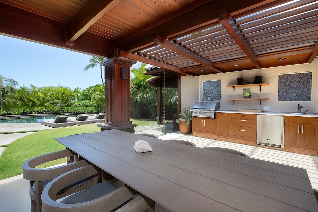Grill, dine, and enjoy tropical breezes in this stunning outdoor space.