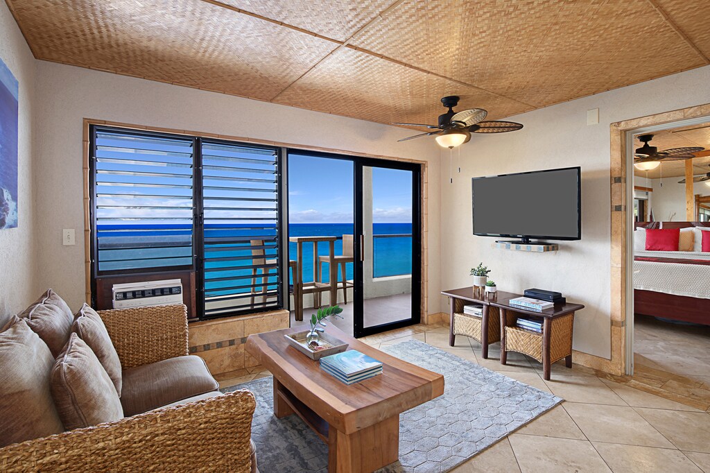 Relax in the breezy living room with ocean views just beyond the sliding doors.