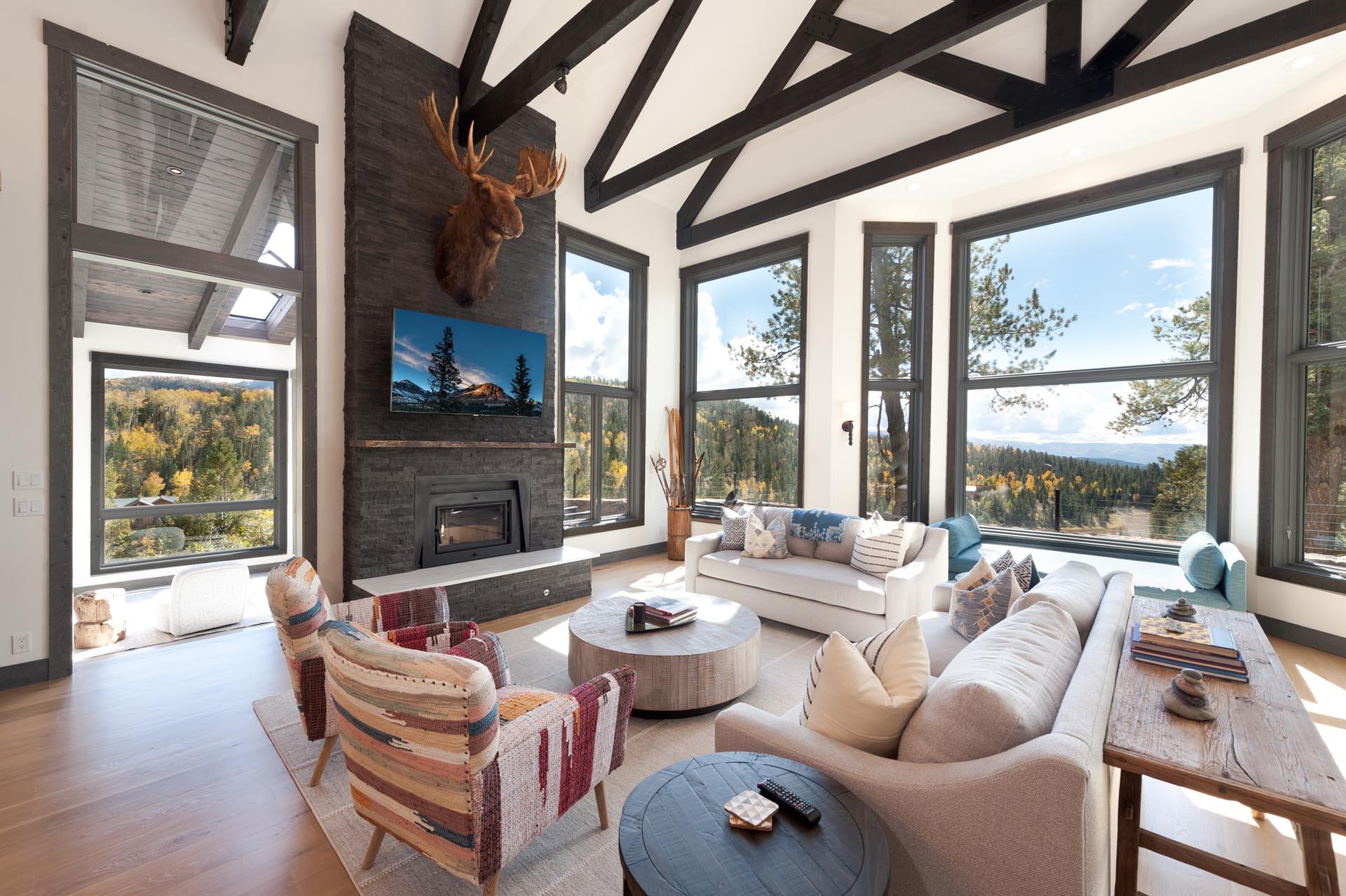 Main Living Space - TV, Wood Burning fireplace and amazing views from the floor to ceiling windows