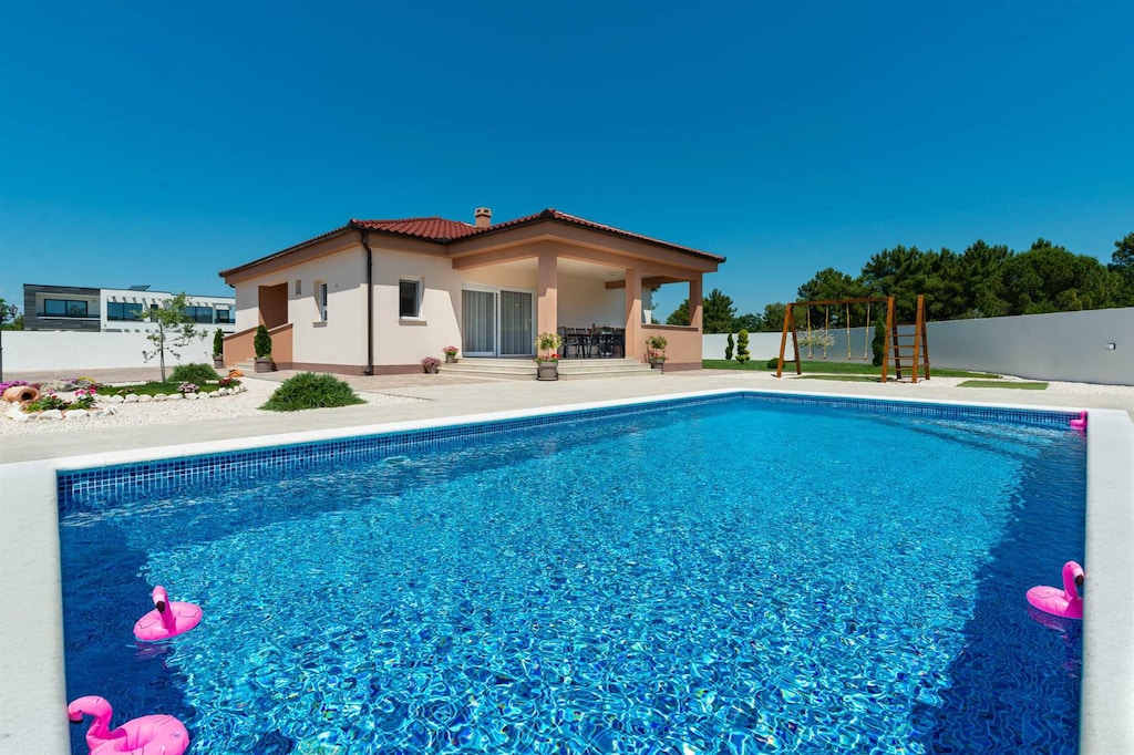 Villa with heated swimming pool and large patio with children`s play area, BBQ and sunloungers with shade covers available