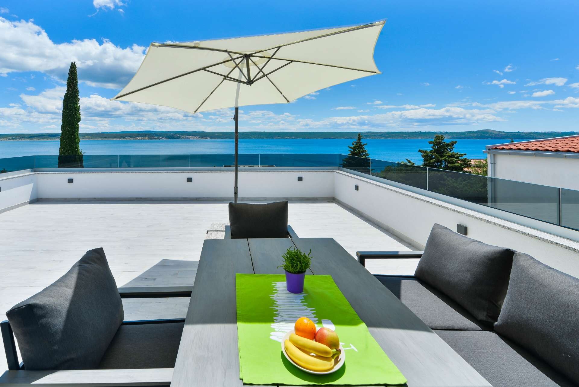 Spacious terrace with dining area on a amazing panoramic sea view.
