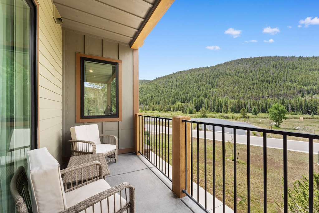Spacious private balcony with cozy outdoor seating. 