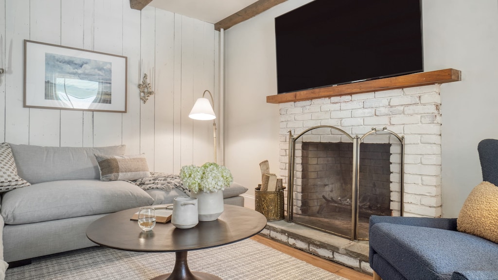 The living room features a fireplace and TV.