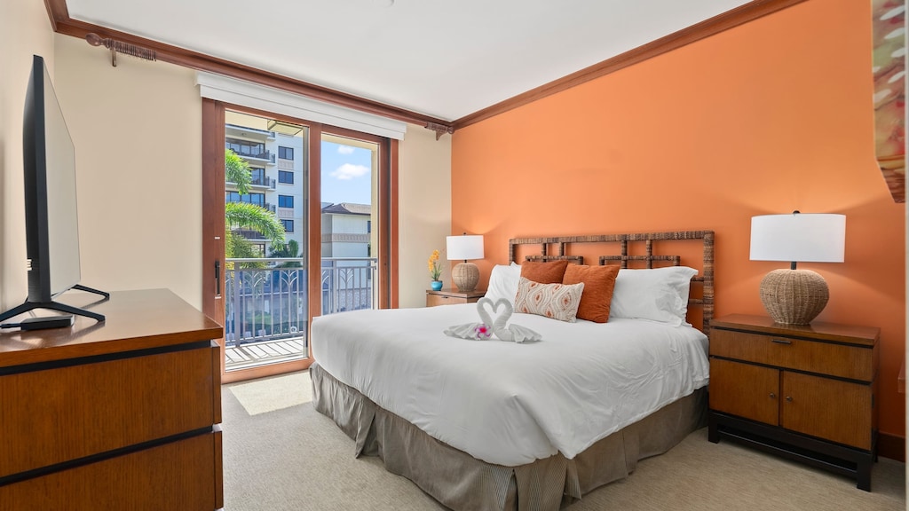 Primary bedroom features a king bed, balcony, ensuite bathroom, and TV.