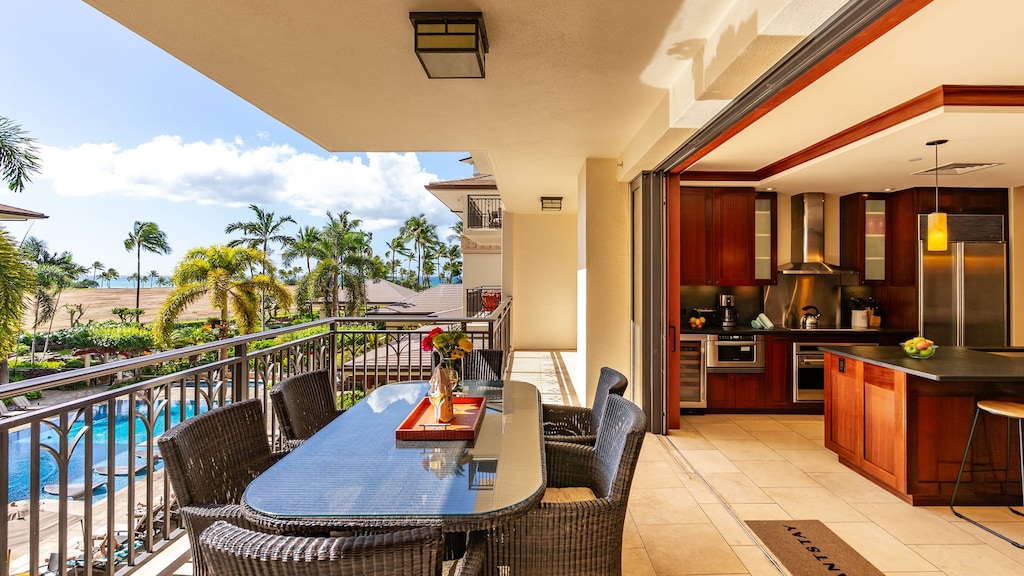 Seamless indoor–outdoor living with a private lanai overlooking the resort pool and tropical grounds.