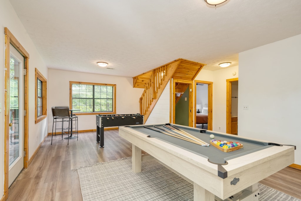 Rec room downstairs features two bedrooms, games, and access to the bottom deck.