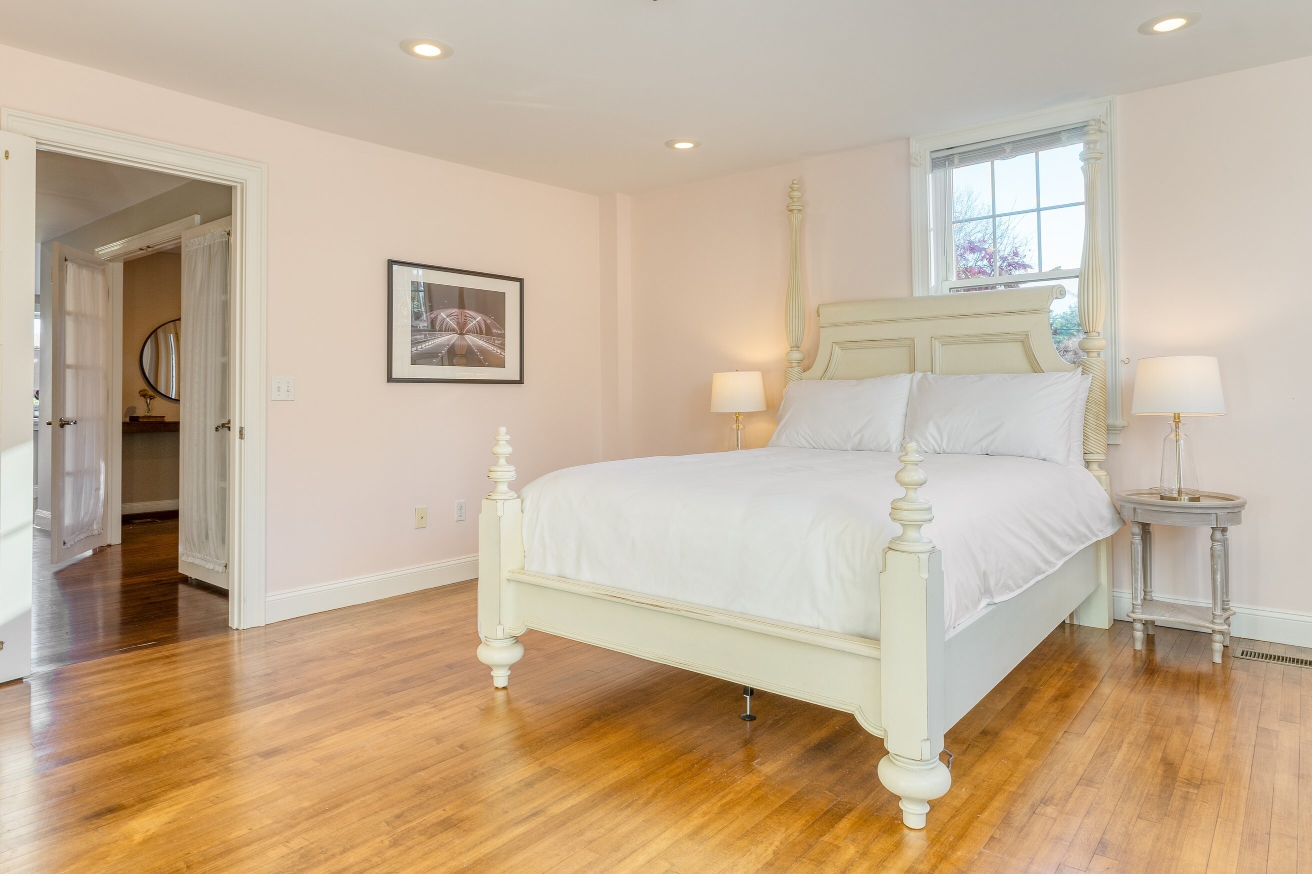 Bedroom 6 is on the first floor of the main house and features a queen bed.