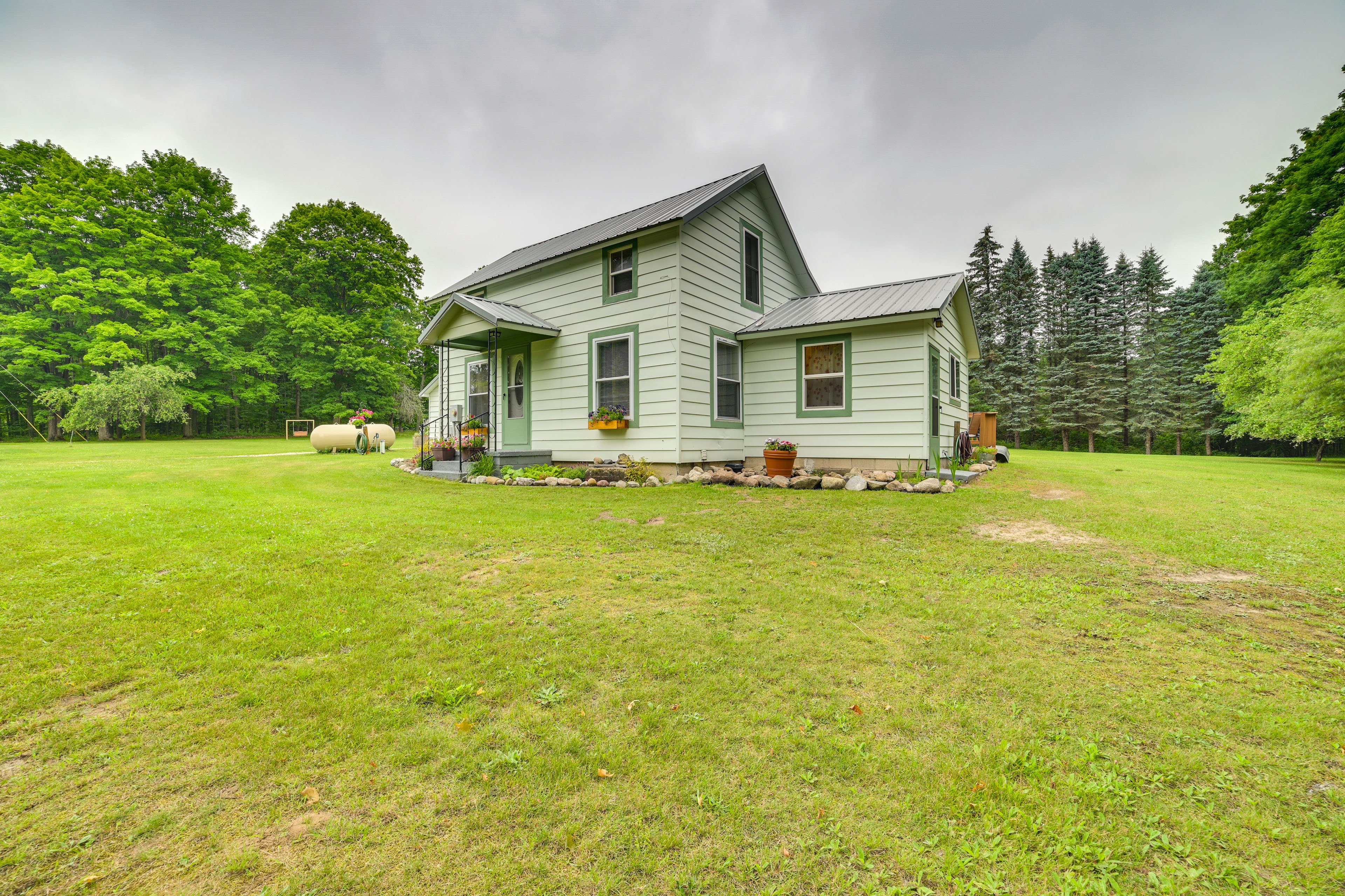 Property Image 1 - Fife Lake Farmhouse: Peaceful Yard & Fire Pit!