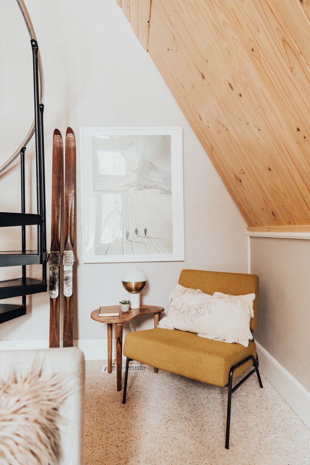 A cozy reading corner with vintage skis in the main living area