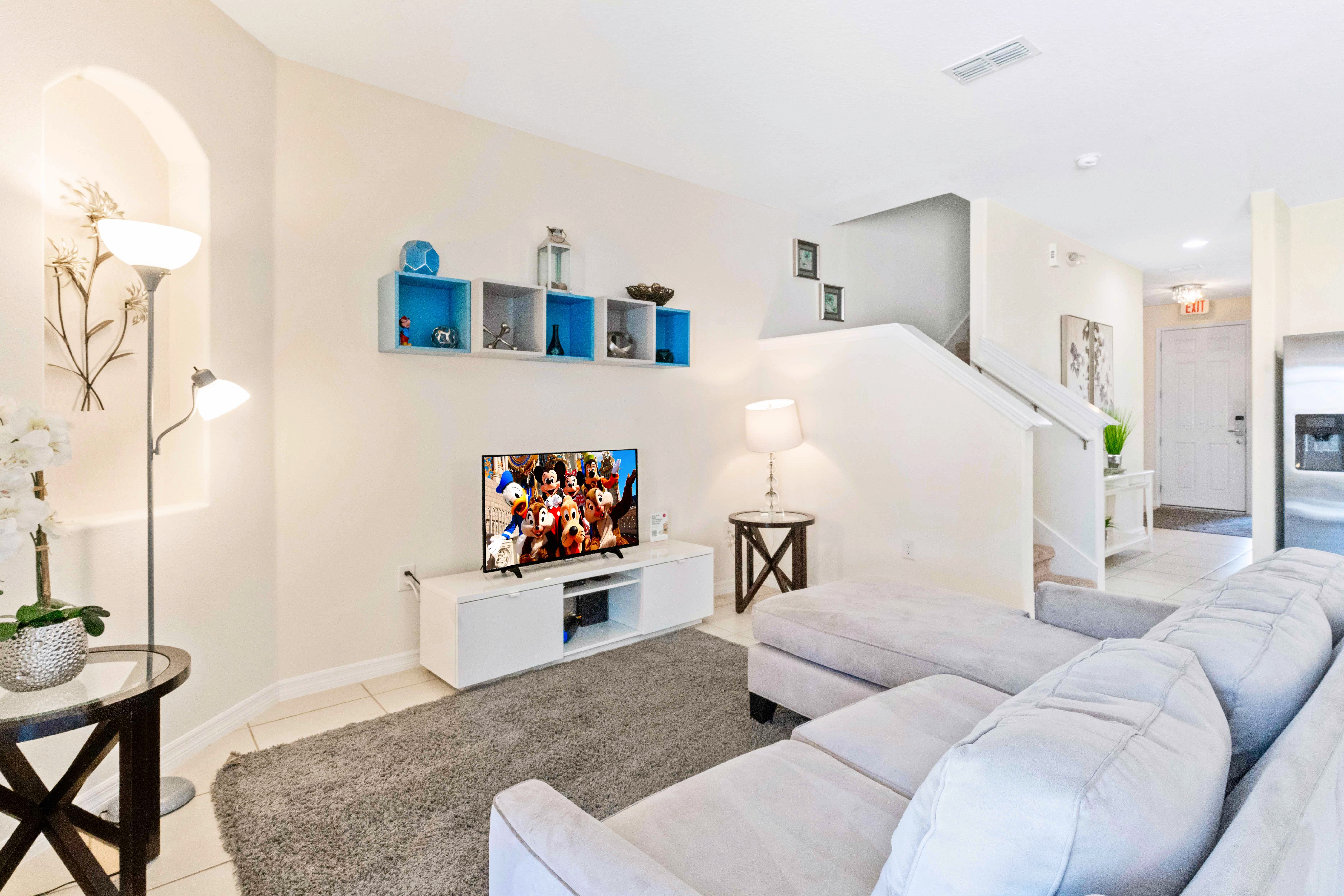 Welcoming Living area of the townhouse in Davenport Florida - Elegantly decorated space with a neutral color palette for a timeless appeal - Well-chosen lighting fixtures adding both functionality and charm - Comfy sofas and Smart TV