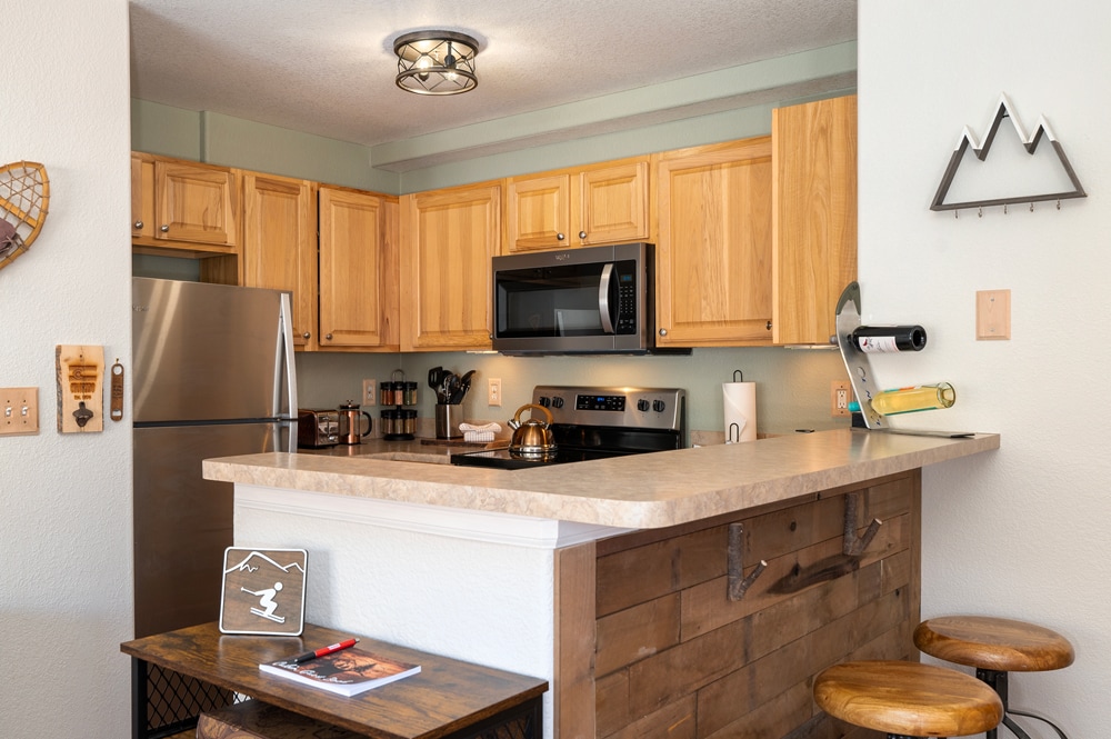 Cook your favorite meals in your fully equipped kitchen with modern appliances, granite counters, and rustic mountain charm.