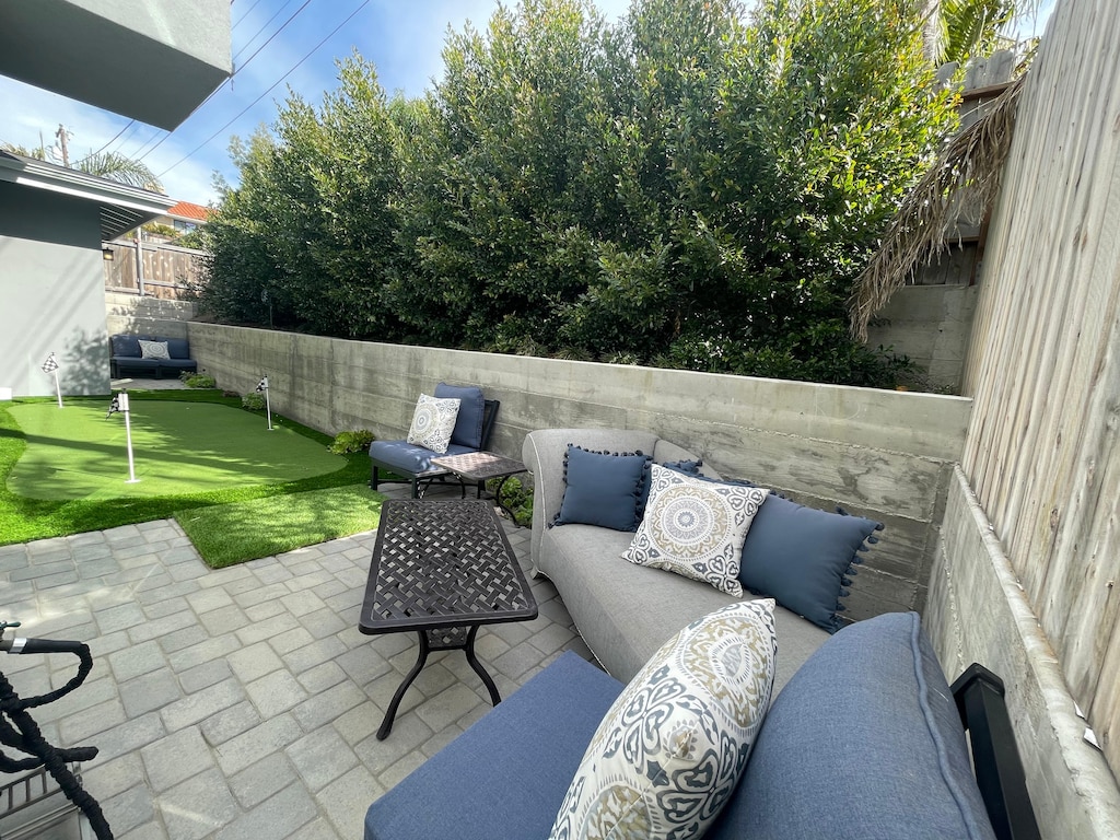 Outdoor seating with adjacent putting green.