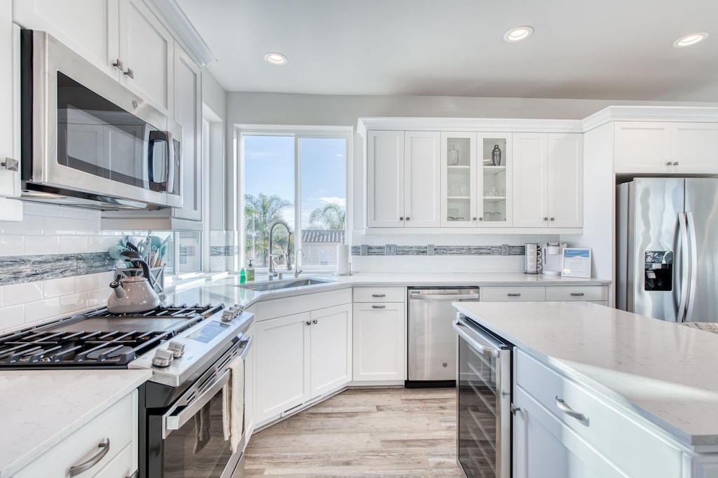 Stainless steel appliances and a 6-burner range. 