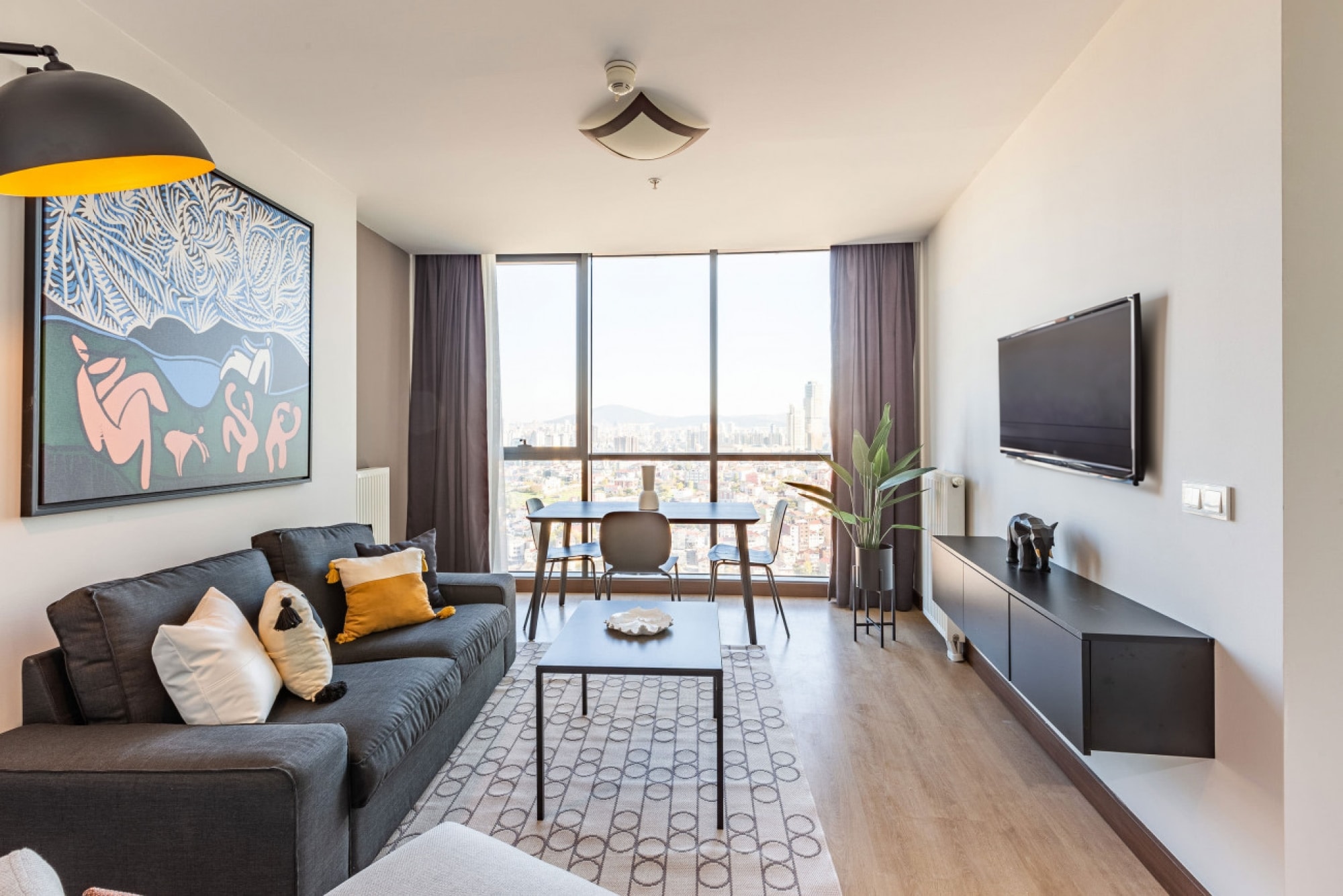 A welcoming living room featuring an expansive bay window that floods the room with sunlight.