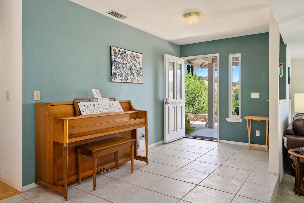 Upright piano greets you in the entryway