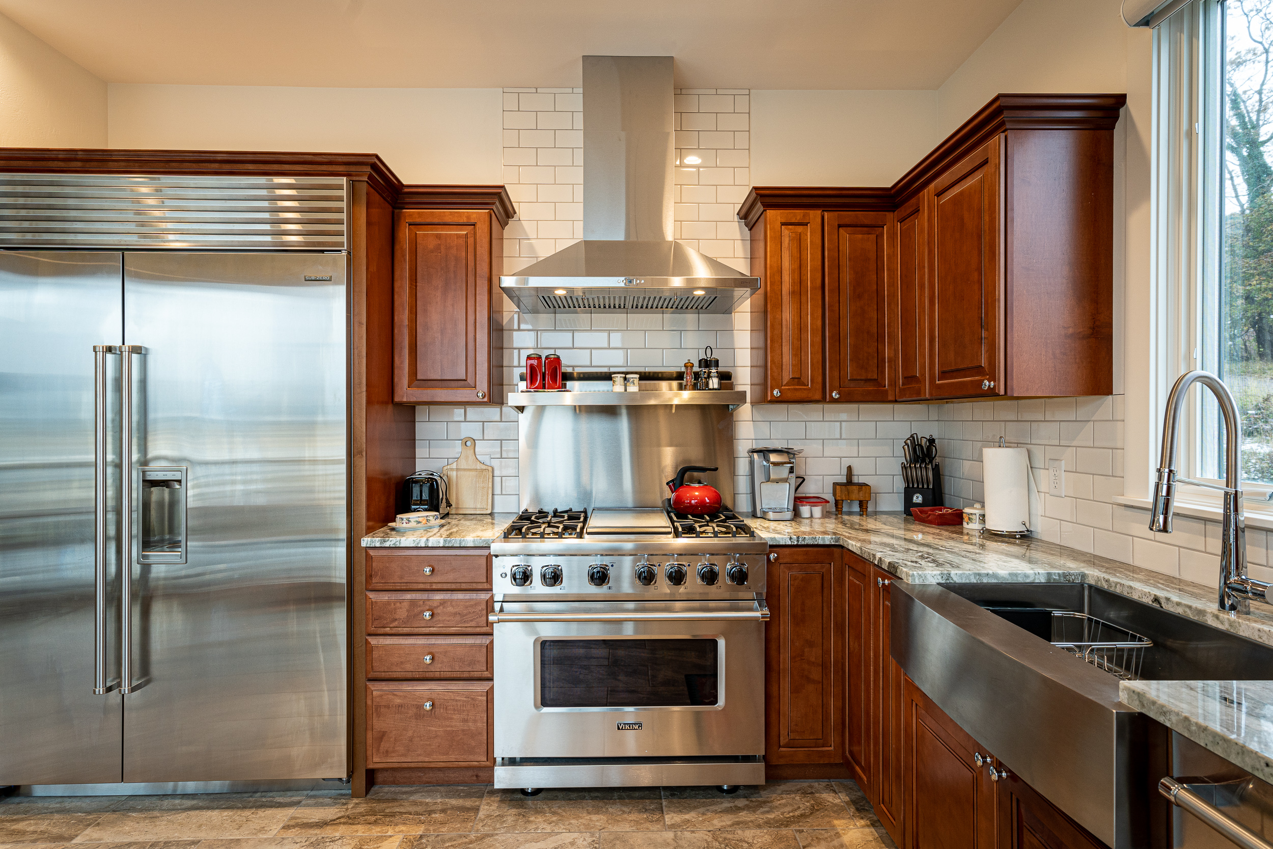 In the kitchen, you will find a butcher block floating island and top of the line appliances including a Sub-Zero extra wide refrigerator, dual-heat Viking oven, convection oven, and vented hood.