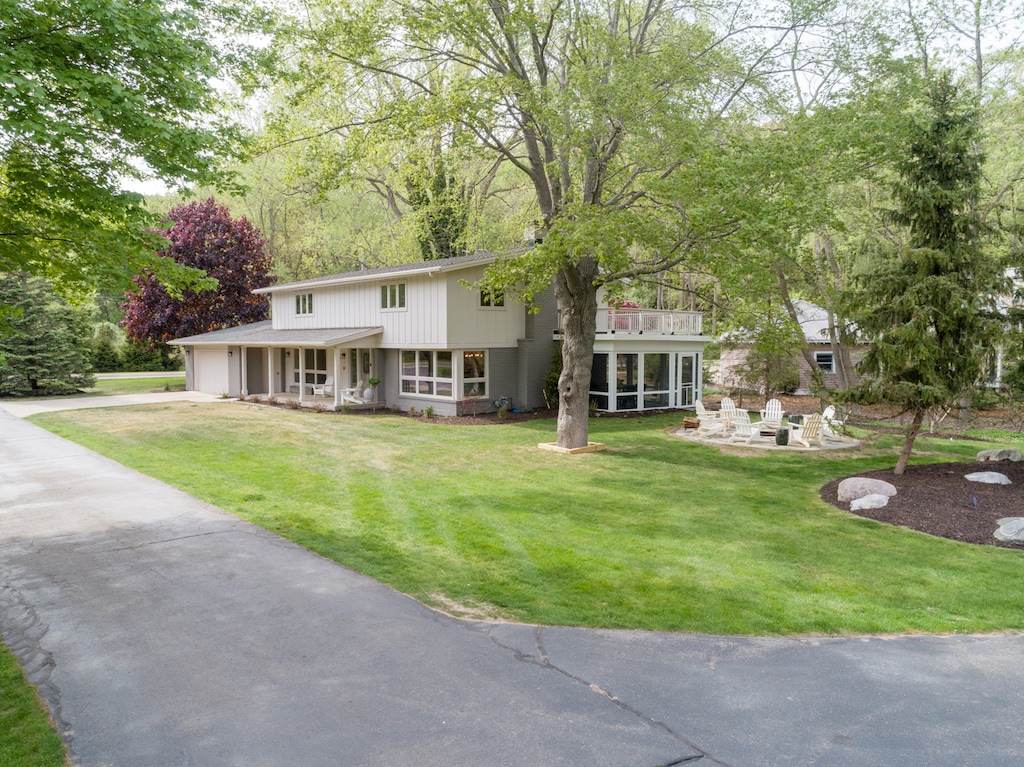 This five bedroom cottage sits in the heart of Saugatuck just over a mile from Oval Beach.