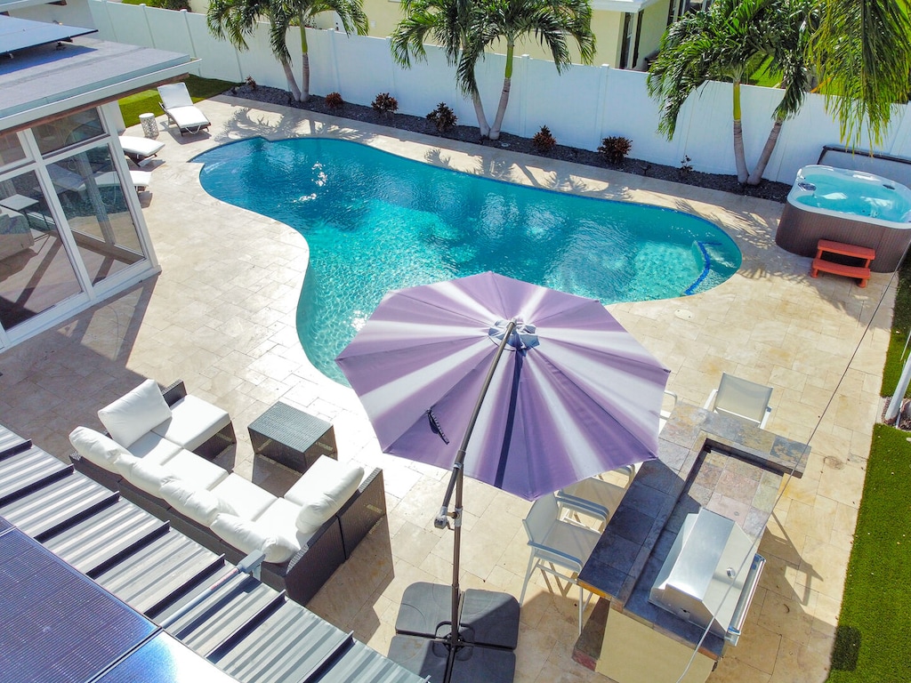 Heated Pool & Hot Tub with outdoor seating and dining area with BBQ
