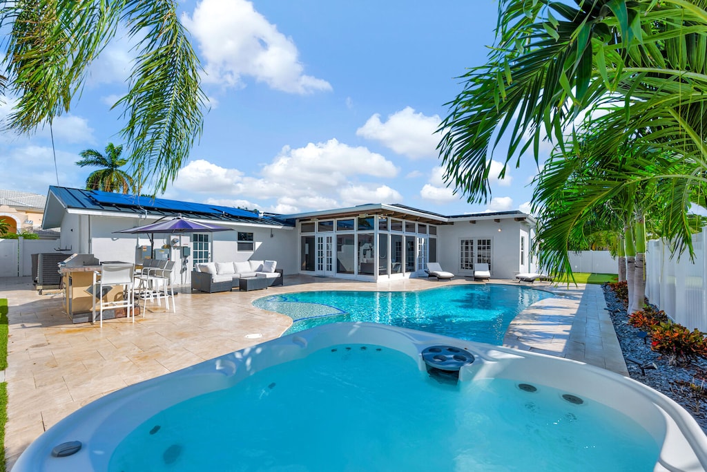 Heated Pool & Hot Tub with outdoor seating and dining area with BBQ