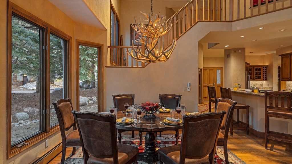 Dining Area, Main Level - Round dining table beneath antler chandelier