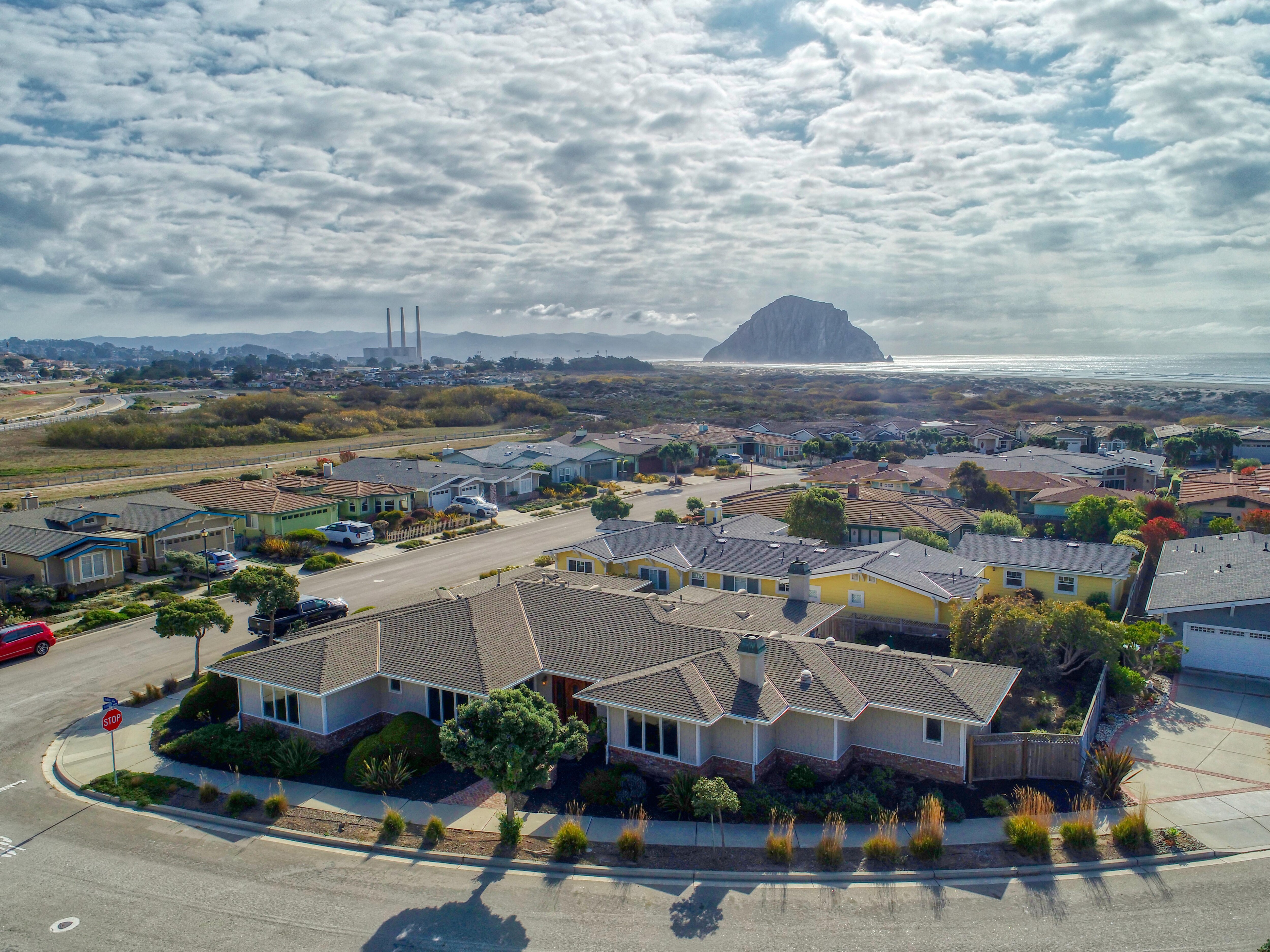 A perimeter of sandy beach and indigo blue ocean engulf this exclusive Morro Bay estate vacation home.