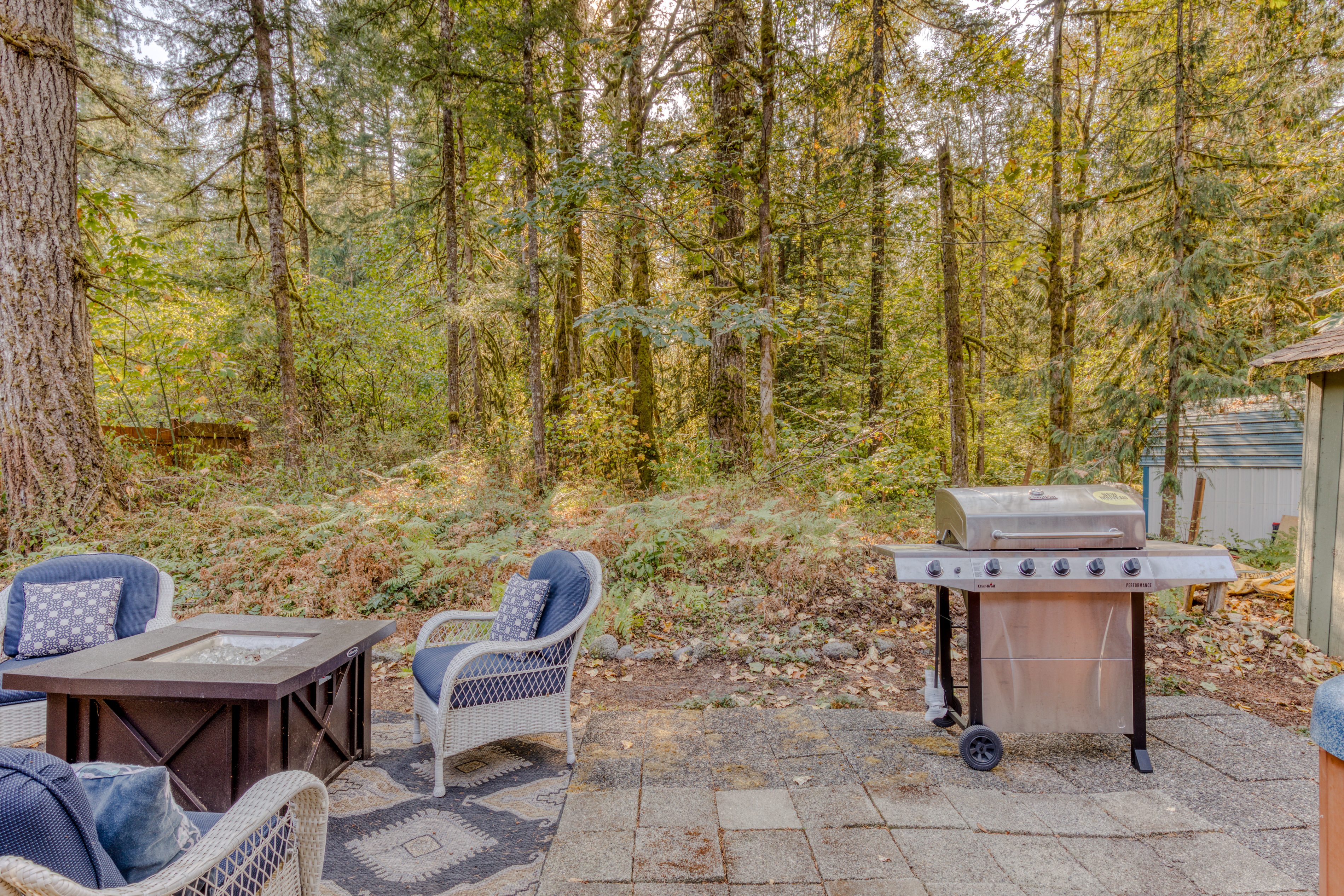 Complete with outdoor seating, a fire pit, and a grill