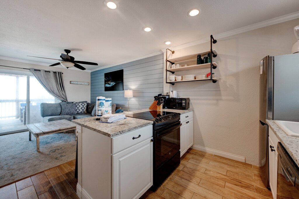 Kitchen looking into living area. Designed for convenience, this cozy kitchen is perfect for whipping up meals on your vacation.