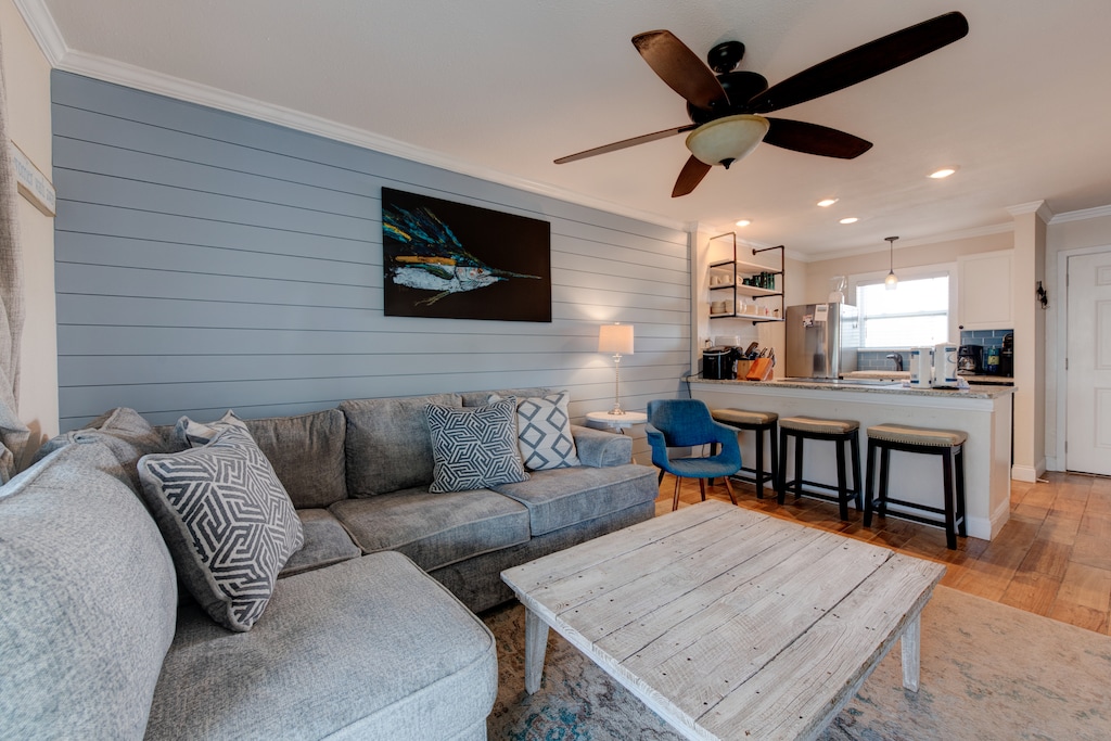 Living area looking into kitchen. The kitchen, dining, and living areas blend seamlessly for a bright and airy feel