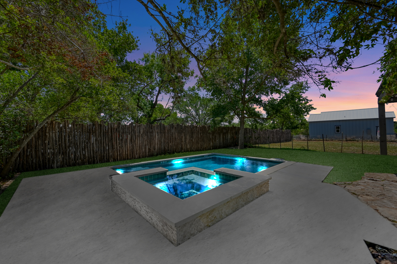 The pool in our backyard features a luxurious built-in hot tub for the perfect relaxation oasis.