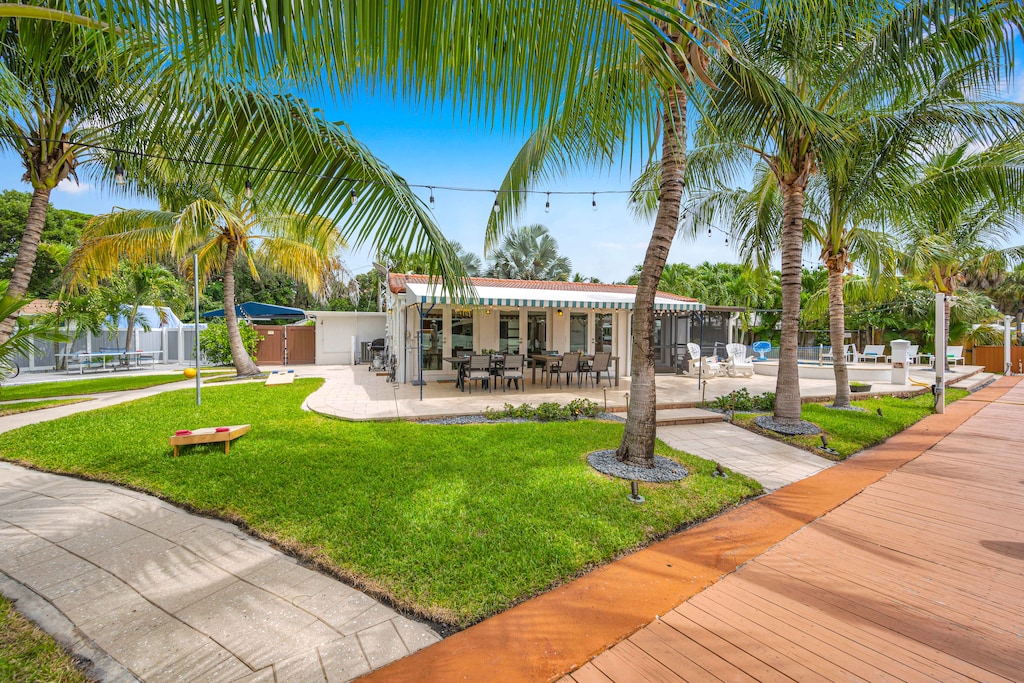 Relax in the greenery of the lush backyard featuring al fresco dinning, a grilling area, heated pool, outdoor games, and the waterfront!